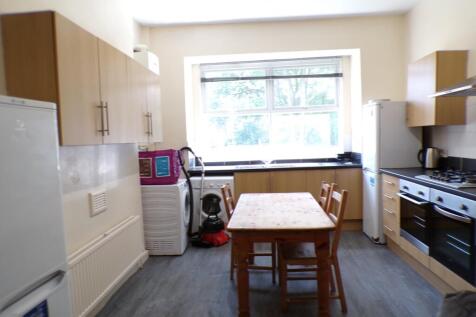 A bright and spacious kitchen with ample storag...