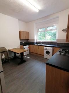 A spacious and well-lit kitchenette with modern...