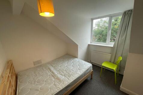 A bright and cozy double bedroom featuring a la...