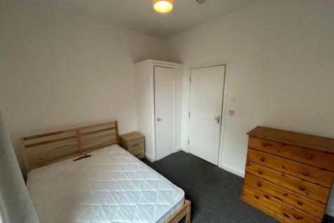 A bright and tidy double bedroom featuring ampl...
