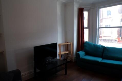 A bright and inviting living room featuring a c...