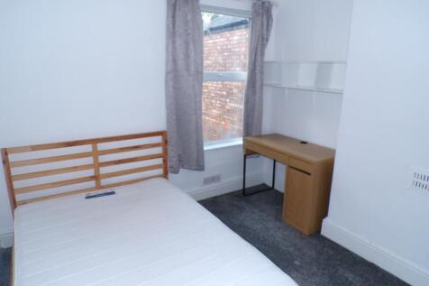 A bright and tidy double bedroom featuring a co...