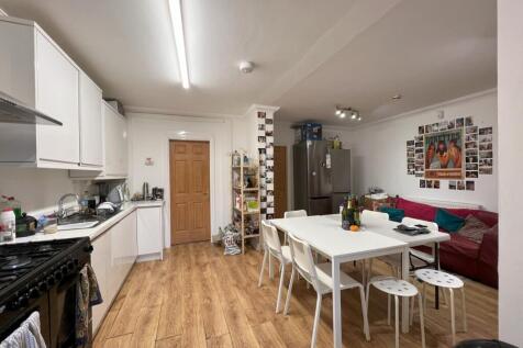 A spacious and inviting kitchen area with moder...