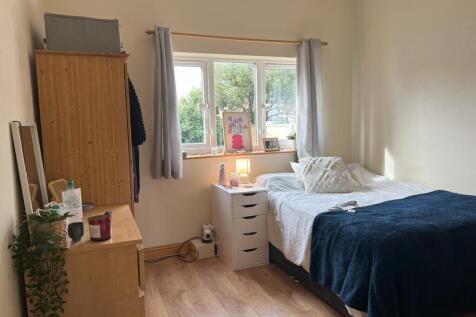 A bright and inviting double bedroom with ample...