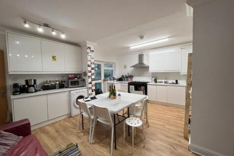 A modern and spacious kitchen with ample natura...