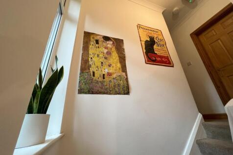A bright and inviting hallway featuring beautif...
