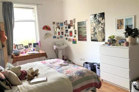 A bright and inviting double bedroom with perso...
