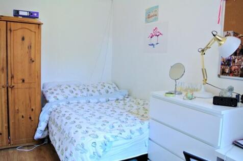A cozy double bedroom with natural light, featu...