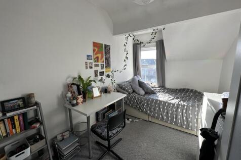 A bright and inviting double bedroom featuring ...