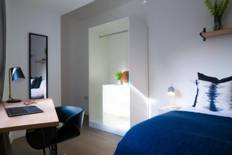 A bright and inviting double bedroom with moder...