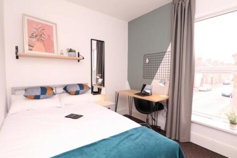 A stylish and inviting double bedroom with ampl...