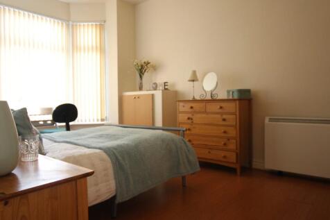A bright and inviting double bedroom with ample...