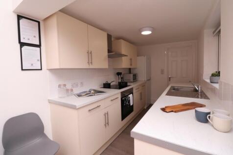 A modern and tidy kitchenette with ample space ...