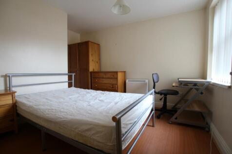 A spacious and bright double bedroom featuring ...