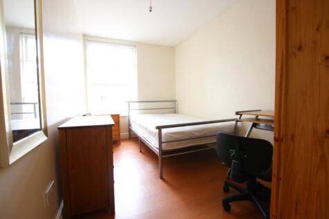 A bright and tidy double bedroom featuring esse...