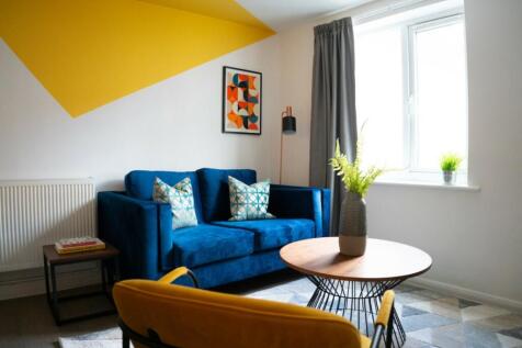 A bright and inviting living room with modern d...