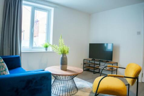 A bright and inviting living room featuring mod...