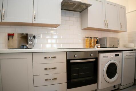 A bright and modern kitchenette equipped with e...