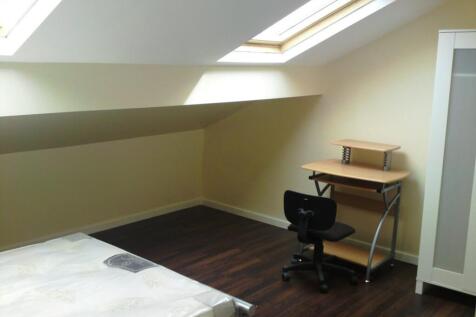 A bright and tidy double bedroom featuring a co...