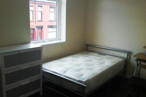 A well-lit double bedroom with ample space for ...