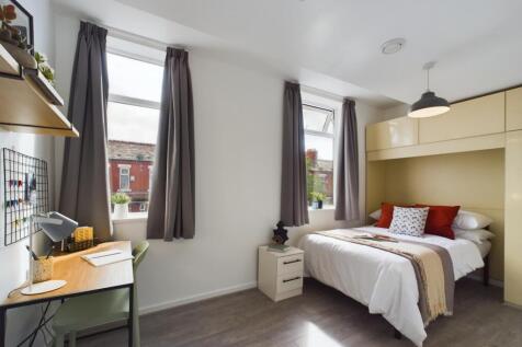 A bright and inviting double bedroom featuring ...