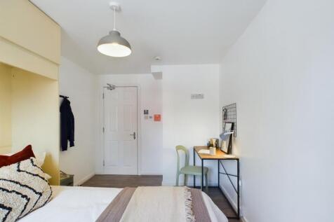 A bright and inviting double bedroom with a coz...