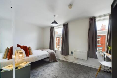 A bright and inviting double bedroom featuring ...