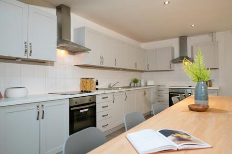 A spacious and modern kitchen with ample storag...