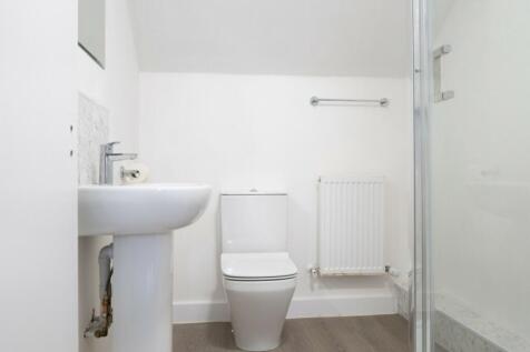 A clean and modern bathroom featuring a stylish...