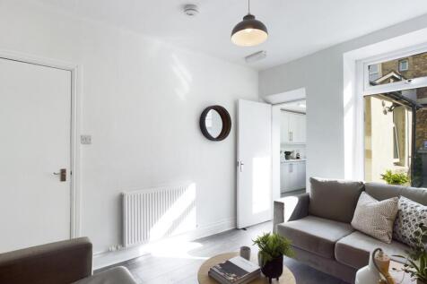 A bright and inviting large modern living room,...