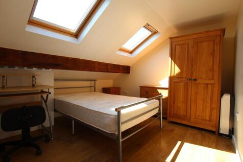 A bright and inviting double bedroom with ample...