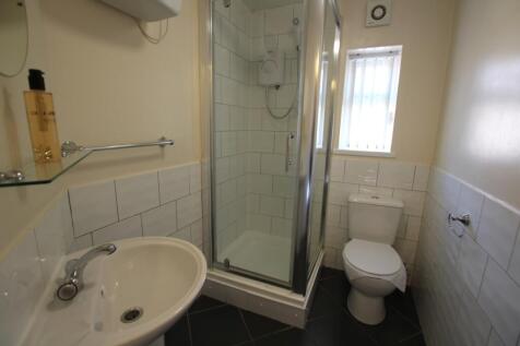 A modern bathroom featuring a clean shower and ...