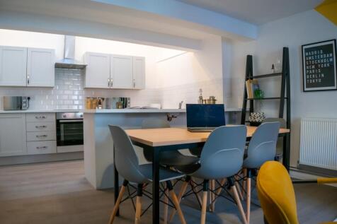 A bright and modern kitchen area featuring a sp...