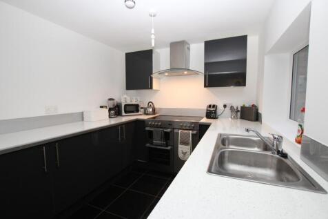 A modern and tidy kitchenette with ample counte...