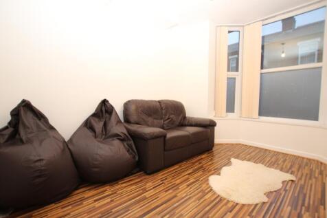 A bright and inviting living room featuring com...