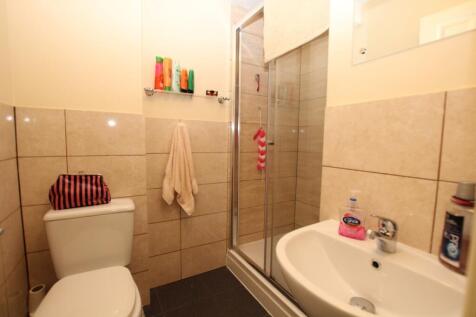 A modern and tidy bathroom featuring a shower a...
