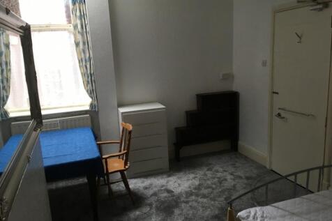 This inviting double bedroom features a cozy at...