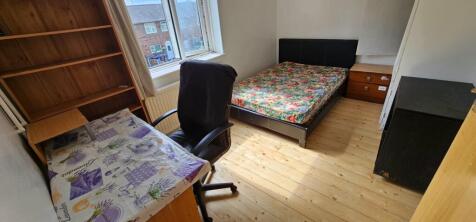 Cozy double bedroom featuring a floral-patterne...