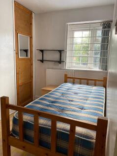 This cozy double bedroom features a comfortable...
