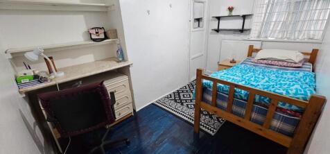 Cozy double bedroom featuring a comfortable bed...