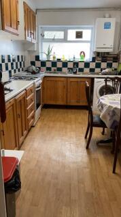 Cozy kitchen with wooden cabinetry and ample sp...