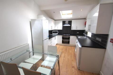 Bright and modern kitchen featuring sleek cabin...
