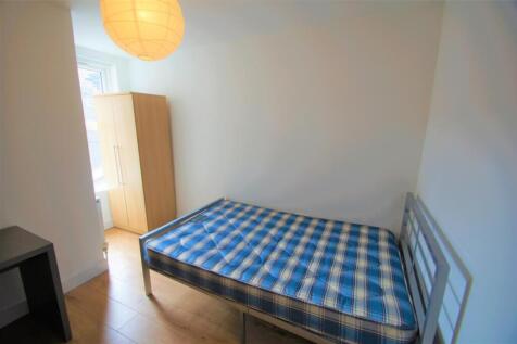 A bright and inviting double bedroom featuring ...