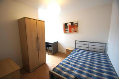 Cozy double bedroom featuring a comfortable bed...