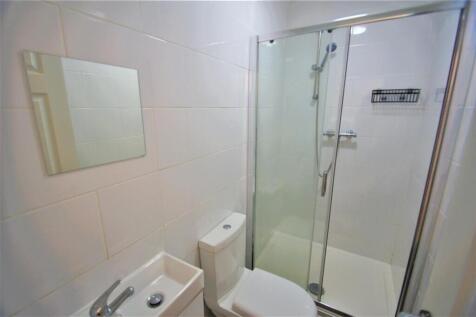 A modern bathroom featuring a sleek shower stal...