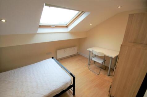 Bright and cozy double bedroom featuring a skyl...