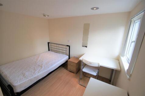 This cozy single bedroom features a comfortable...
