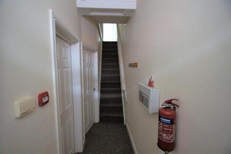 A well-maintained staircase with clean carpetin...