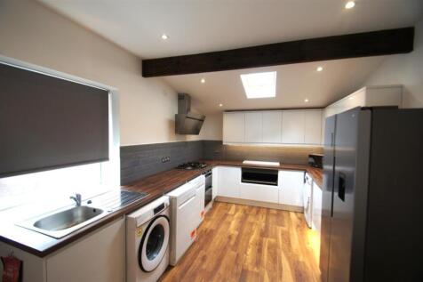 Modern kitchen featuring sleek cabinetry, ample...