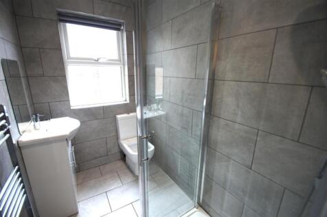 A modern bathroom featuring sleek tiles and a s...